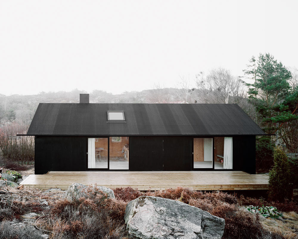 Rock the Shack page spread showing a black cabin on rocks
