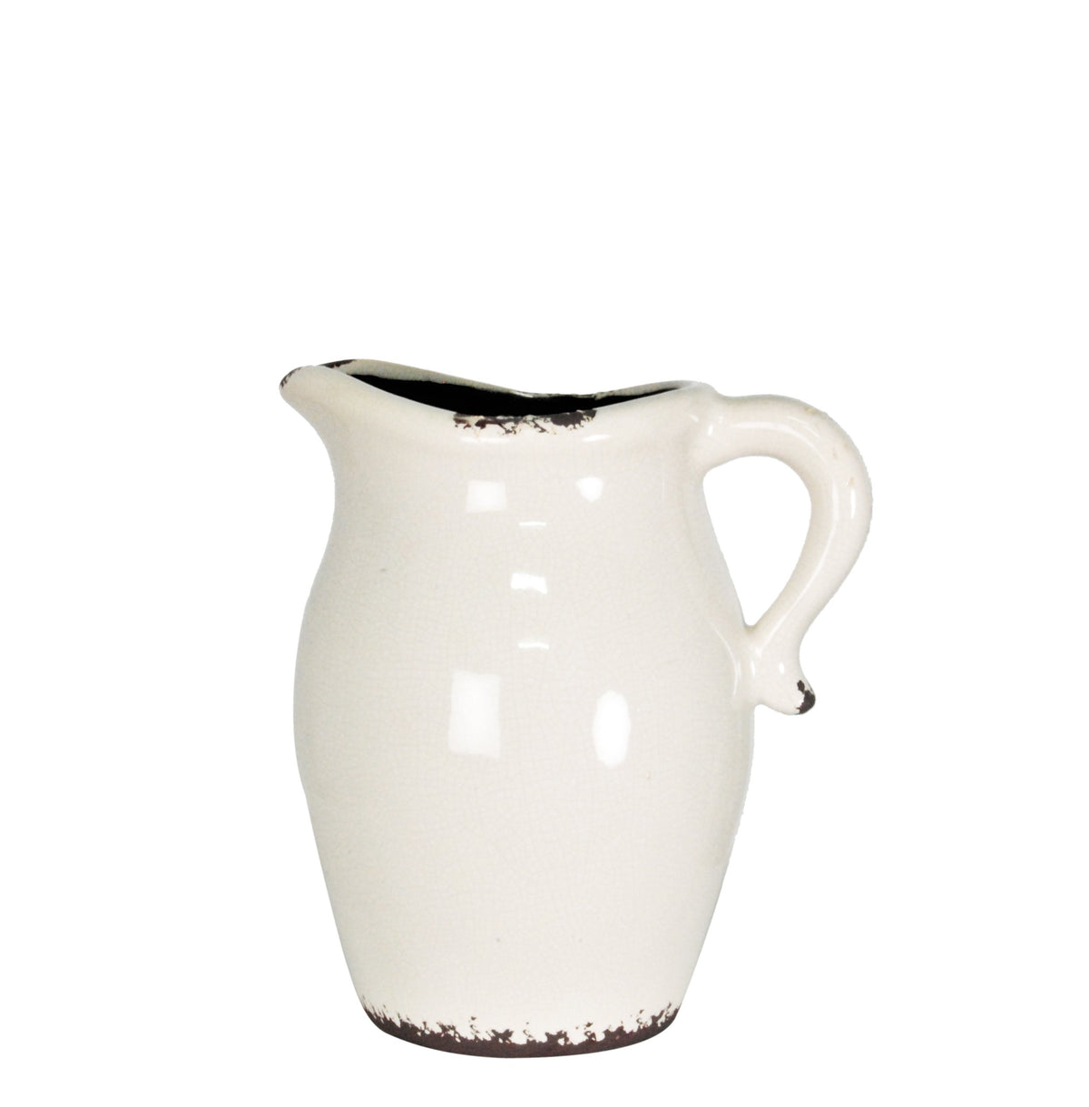 Cream glazed stoneware jug with a curved handle and pinched lip, dark speckling at rim and base