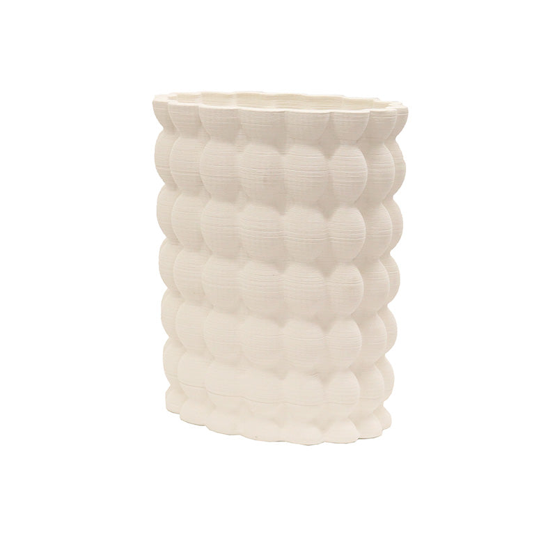 Ribbed vase from another angle, the bobbled surface catching soft light