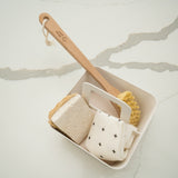 Good Change eco scrubs made from loofah and wood cellulose beside a kitchen sink