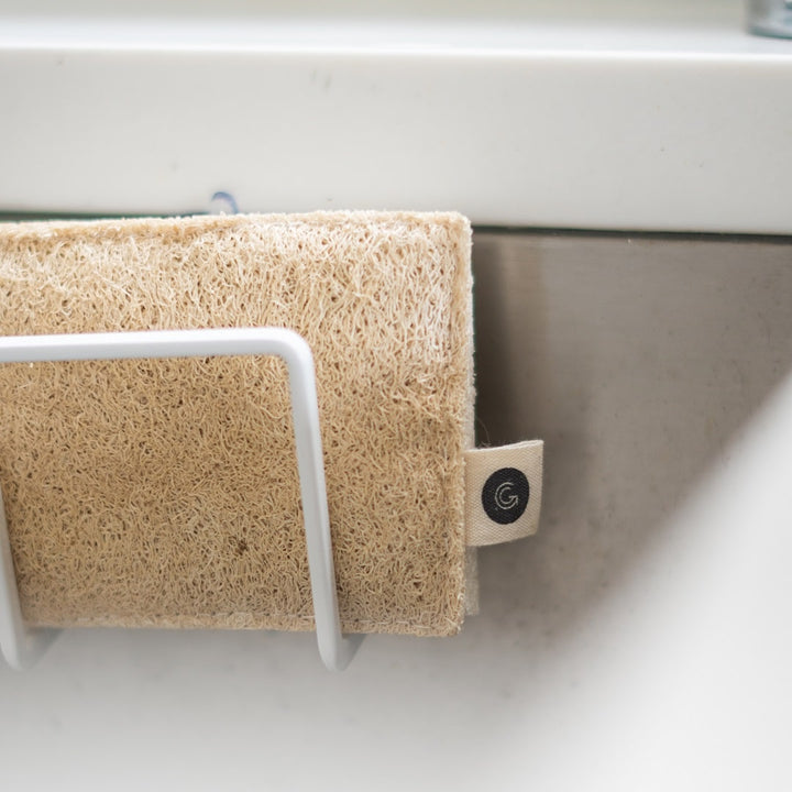 A Good Change ECO SCRUBS 2-PACK dish towel hanging on a hook in a kitchen.
