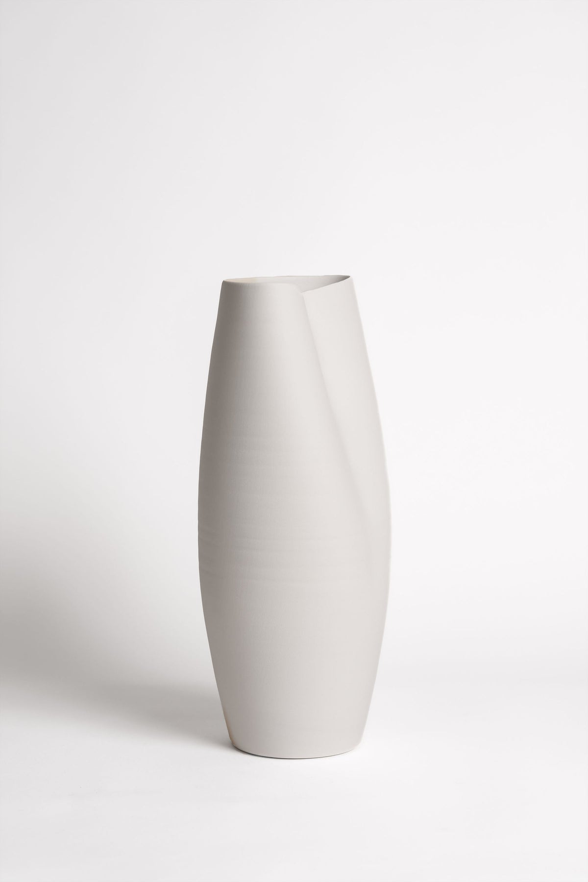 Knew Vase small size styled on a bedside table with a single stem