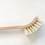 Close up of the tampico bristle head on the Good Change wooden dish brush