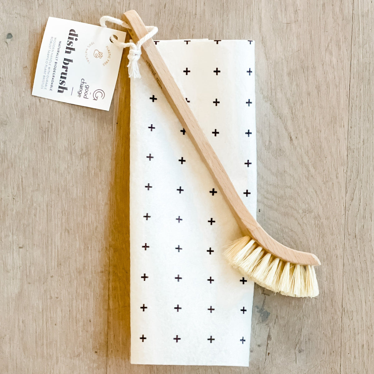 Wooden dish brush on a wooden surface, sustainable kitchen essential