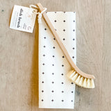 Wooden dish brush on a wooden surface, sustainable kitchen essential
