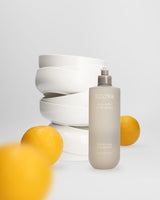 Ecoya Tahitian Lime & Grapefruit kitchen dish wash with stacked white ceramic bowls and lemons