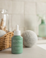 Ecoya wool dryer balls beside a dryer with linen
