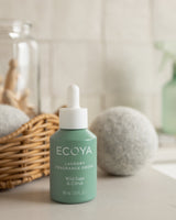 Ecoya Wild Sage and Citrus fragrance drops styled in a laundry with wool dryer balls