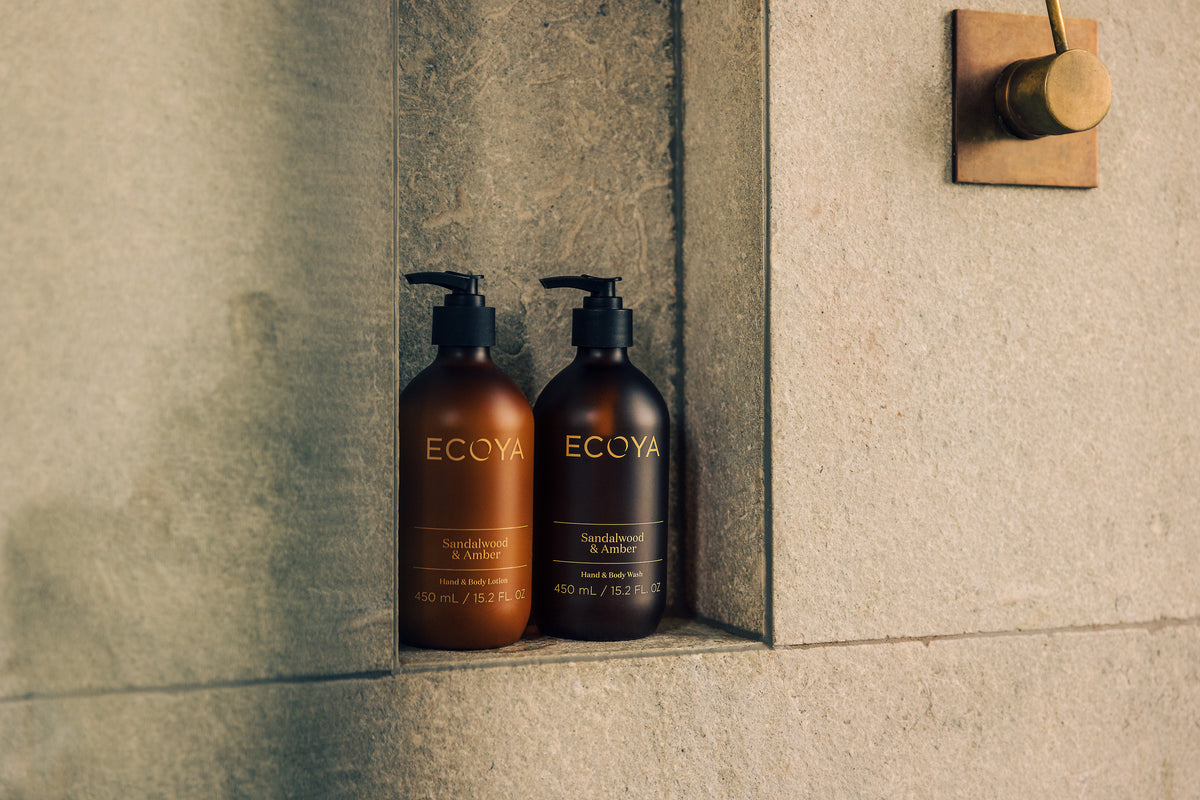 Ecoya Sandalwood & Amber shampoo and conditioner in a stone shower niche