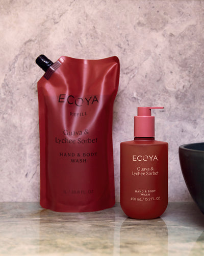 Ecoya Guava & Lychee Sorbet refill pouch beside the 450ml bottle on stone