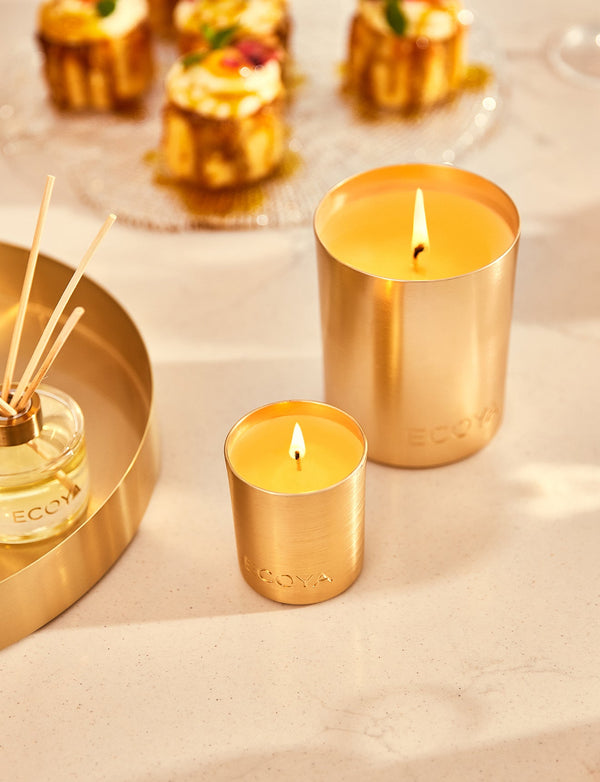 An Ecoya Holiday: Fresh Pine Mini Diffuser sits on a tray next to a cake.