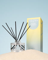 Ecoya Sea Salt and Coconut reed diffuser styled on a console in a coastal home