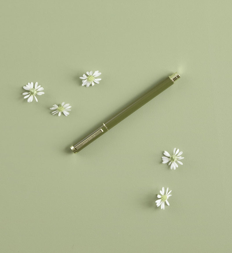 Metal Rollerball Pen in Wild styled on desk with notebook by Emma Kate Co