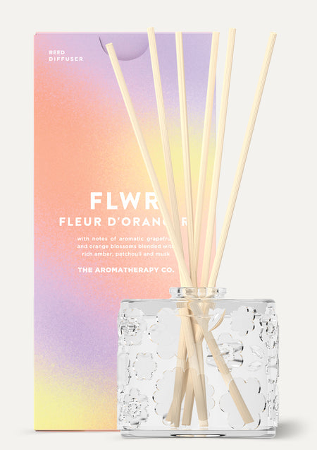 The Fleur D'Oranger diffuser beside its pastel gradient FLWR carton, shown on white
