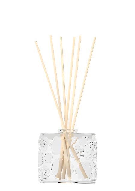 The FLWR Forget Me Not reed diffuser in embossed glass with pale reeds, shown on white