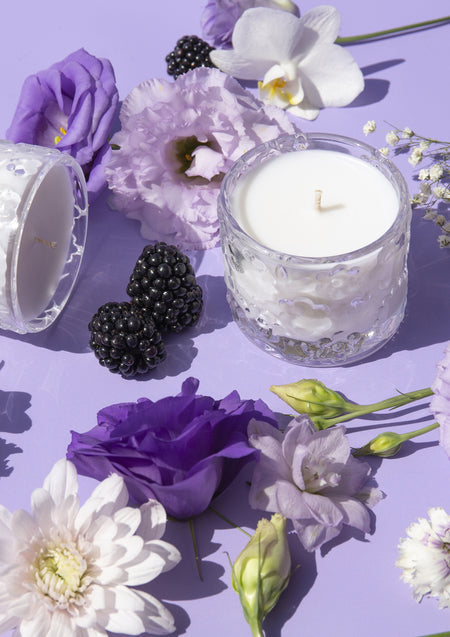 The Purple Reign candle on lilac with purple lisianthus, blackberries and a white orchid