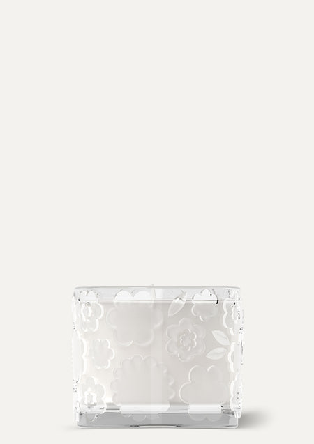 The FLWR Sugared Rose candle in clear embossed glass, unlit on a soft white background