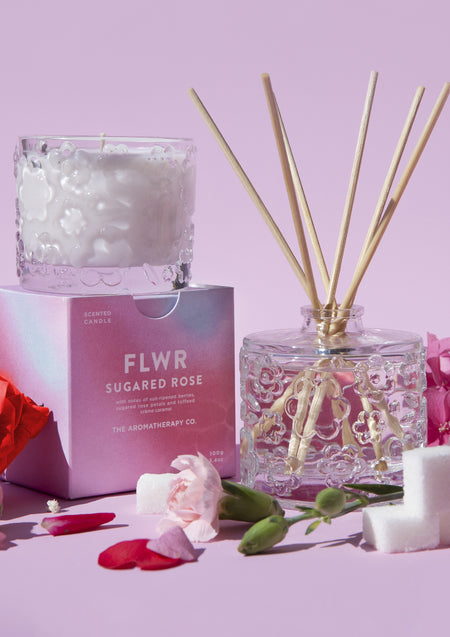 The Sugared Rose diffuser with the candle and pink carton, roses and sugar cubes alongside