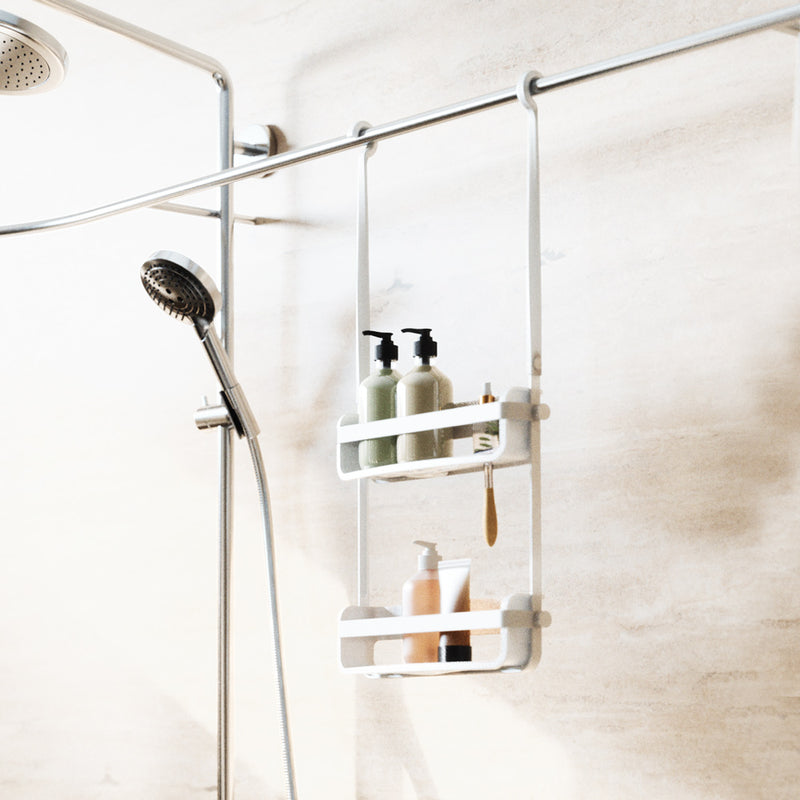 A bathroom with an Umbra Flex Shower Caddy - Black / White and an Umbra range shower head.