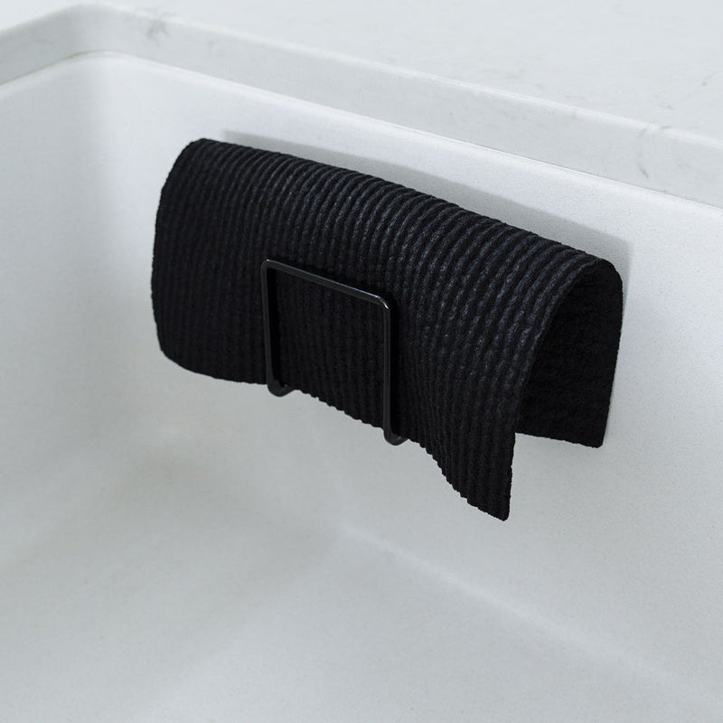 Swedish Dish Cloth being rinsed under a tap