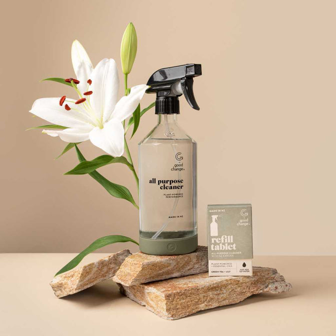 A Good Change all-purpose reusable spray bottle beside a white lily.