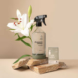 A Good Change all-purpose reusable spray bottle beside a white lily.