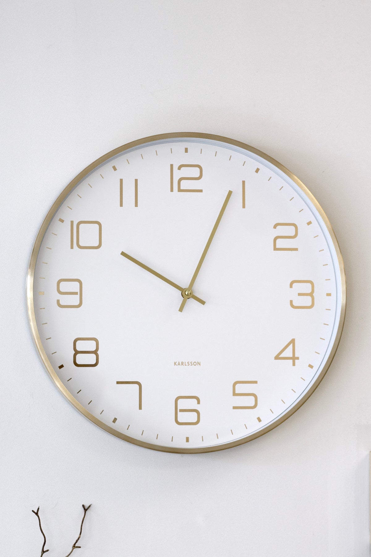 Karlsson Elegance Glow in white hanging on a white wall