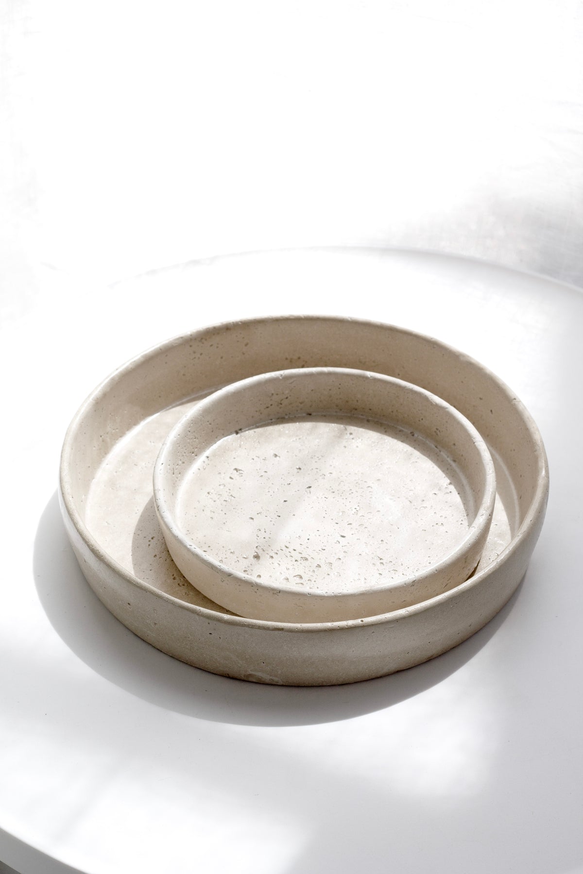 Two Sahara trays stacked on a pale surface