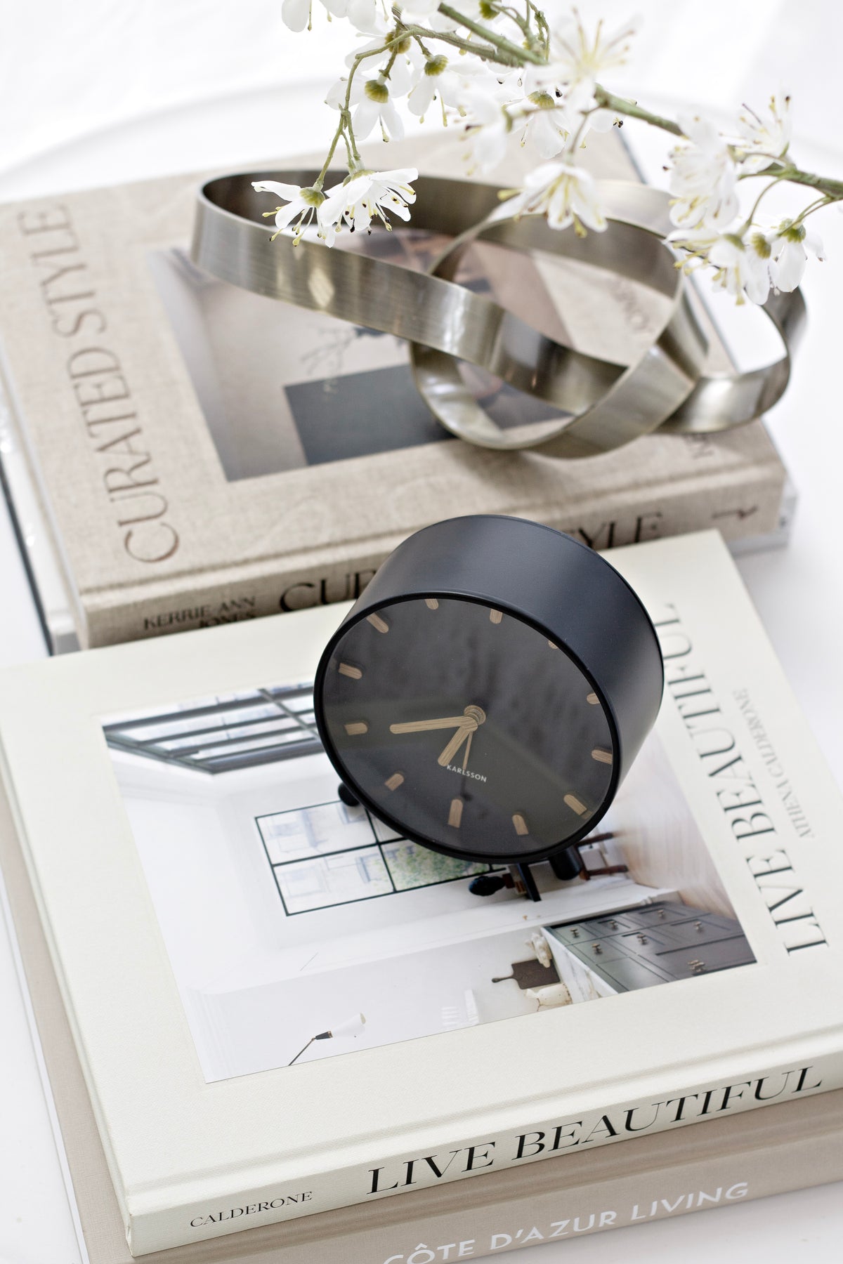 Karlsson Grace Alarm Clock styled on a bedside with soft natural light