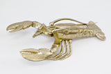 A Lobster Ornament - Gold by Flux Home on a white surface.