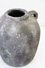 A Flux Home Rustic Vase w/Handle on a white surface.