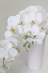 Real Touch Moth Orchid White, by Artificial Flora, in a vase on a white surface.