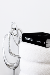 Flux Home's Sculpture 06 - Silver / Gold / Black book is on top of a towel with height.