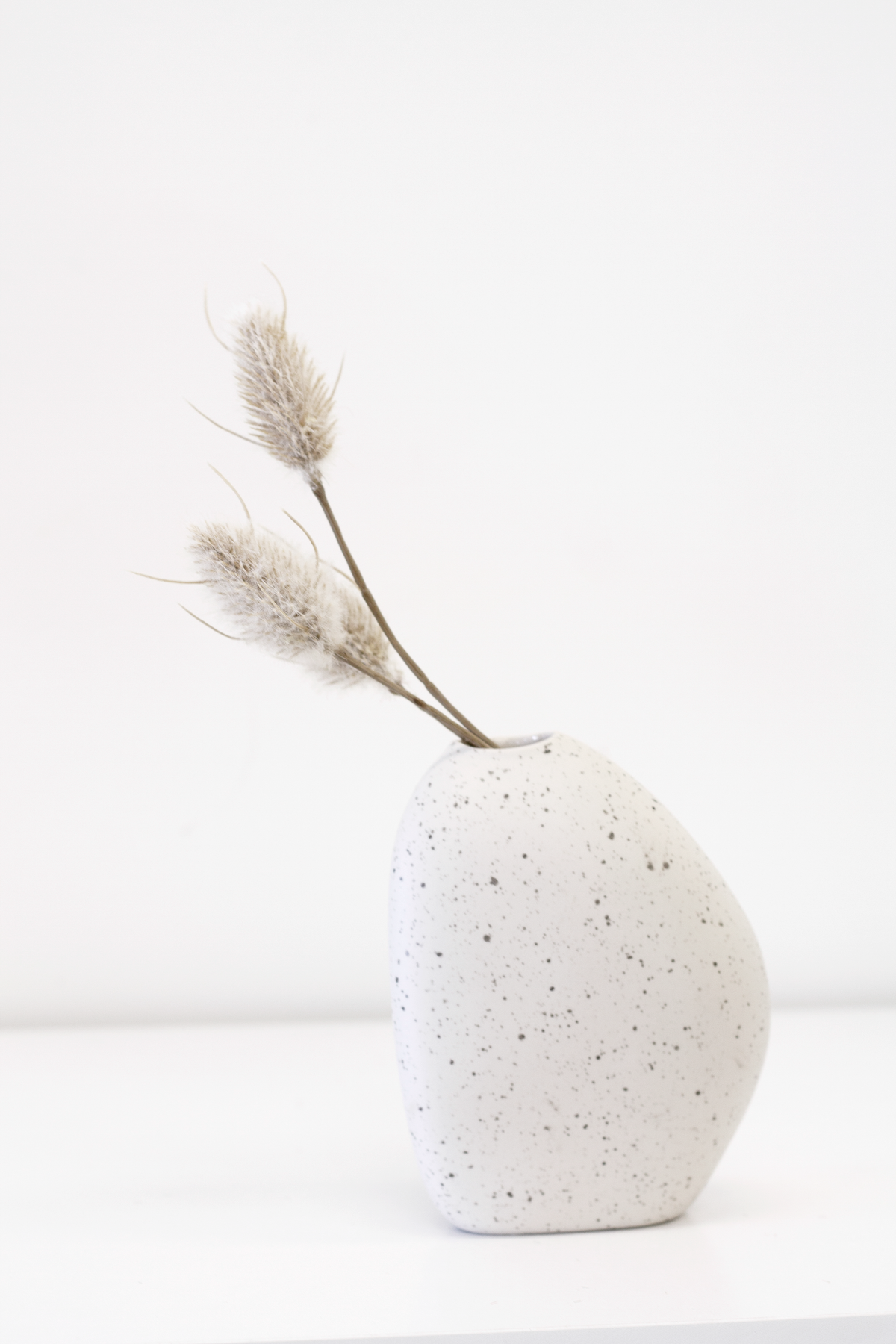 Great Harmie Vase in white and natural styled on a shelf
