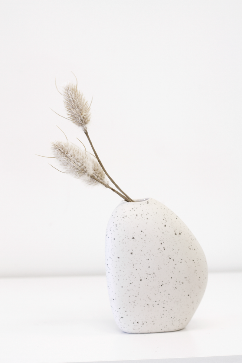 A white Artificial Flora vase with Bunny Tail Pick 35cm in it, adding an element of floral styling.