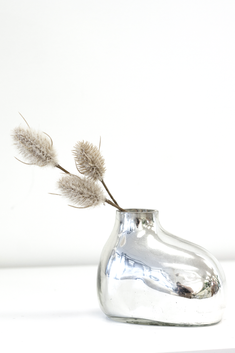 An elegant silver vase filled with Artificial Flora's Bunny Tail Pick 35cm and artificial greenery.