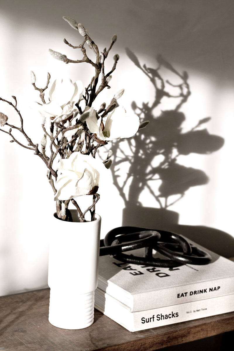 A Limited edition Hubbard Iron Chain from the Bovi Home Collection, adorned with a white flower.