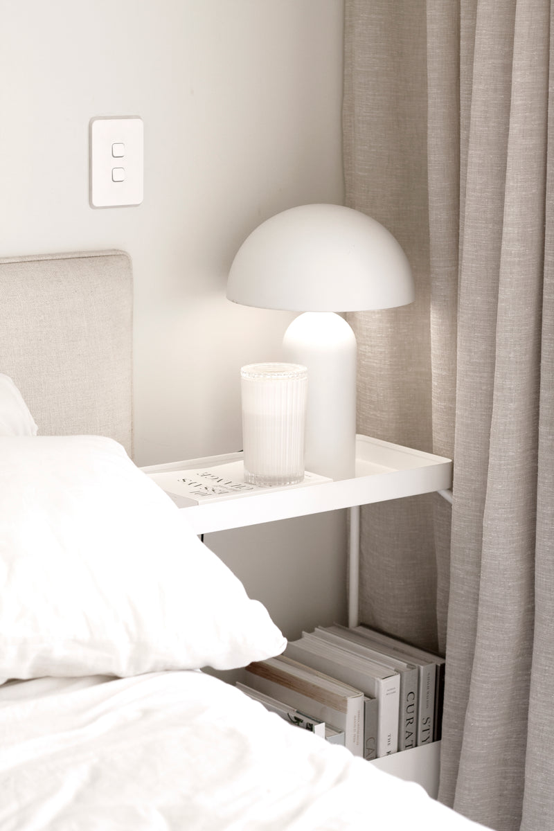 A white bed with a Garcia Home Metal Planter Stand - Various Options on it.