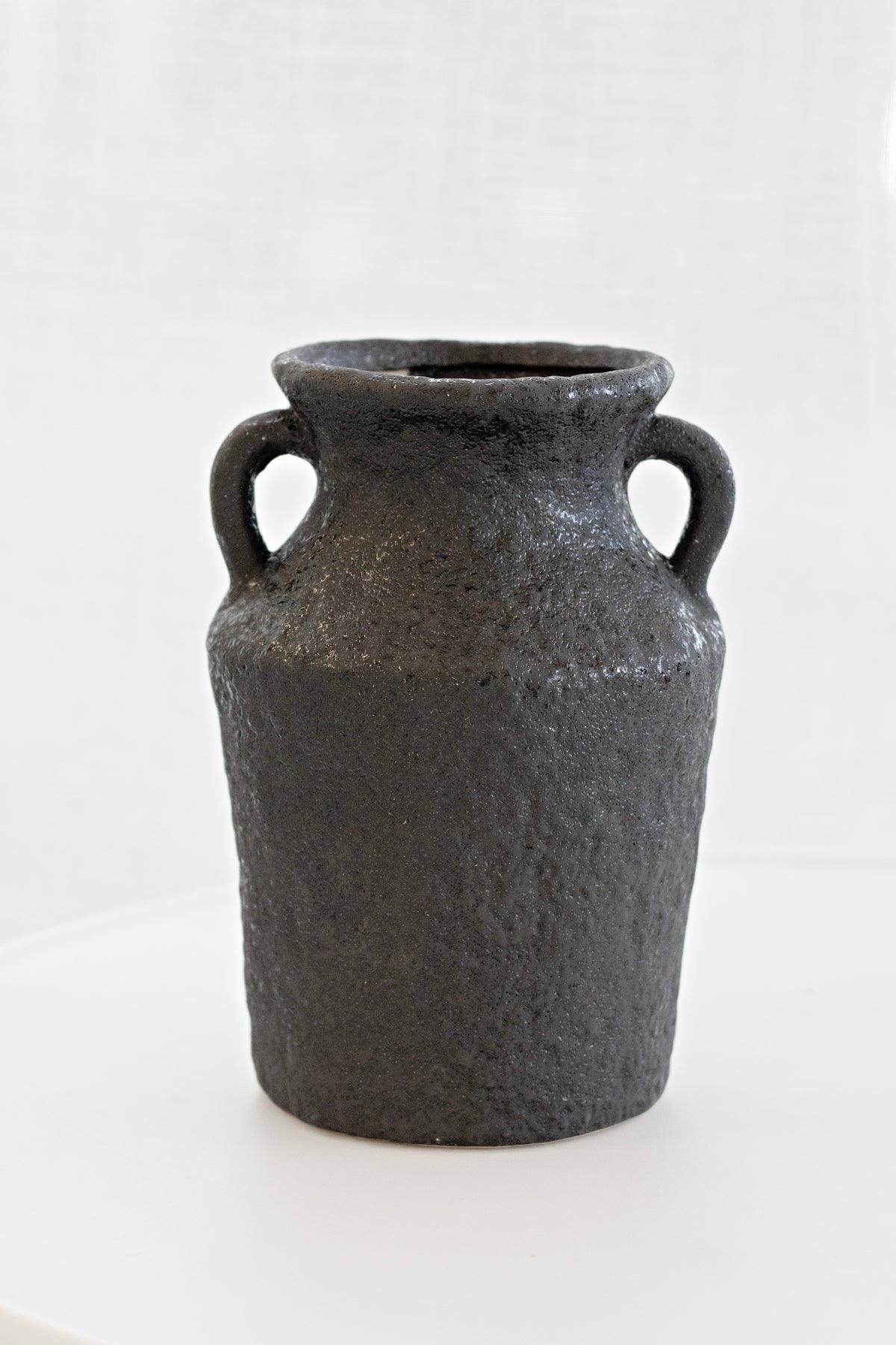 Close view of the Kaia vase showing its rough charcoal stone texture