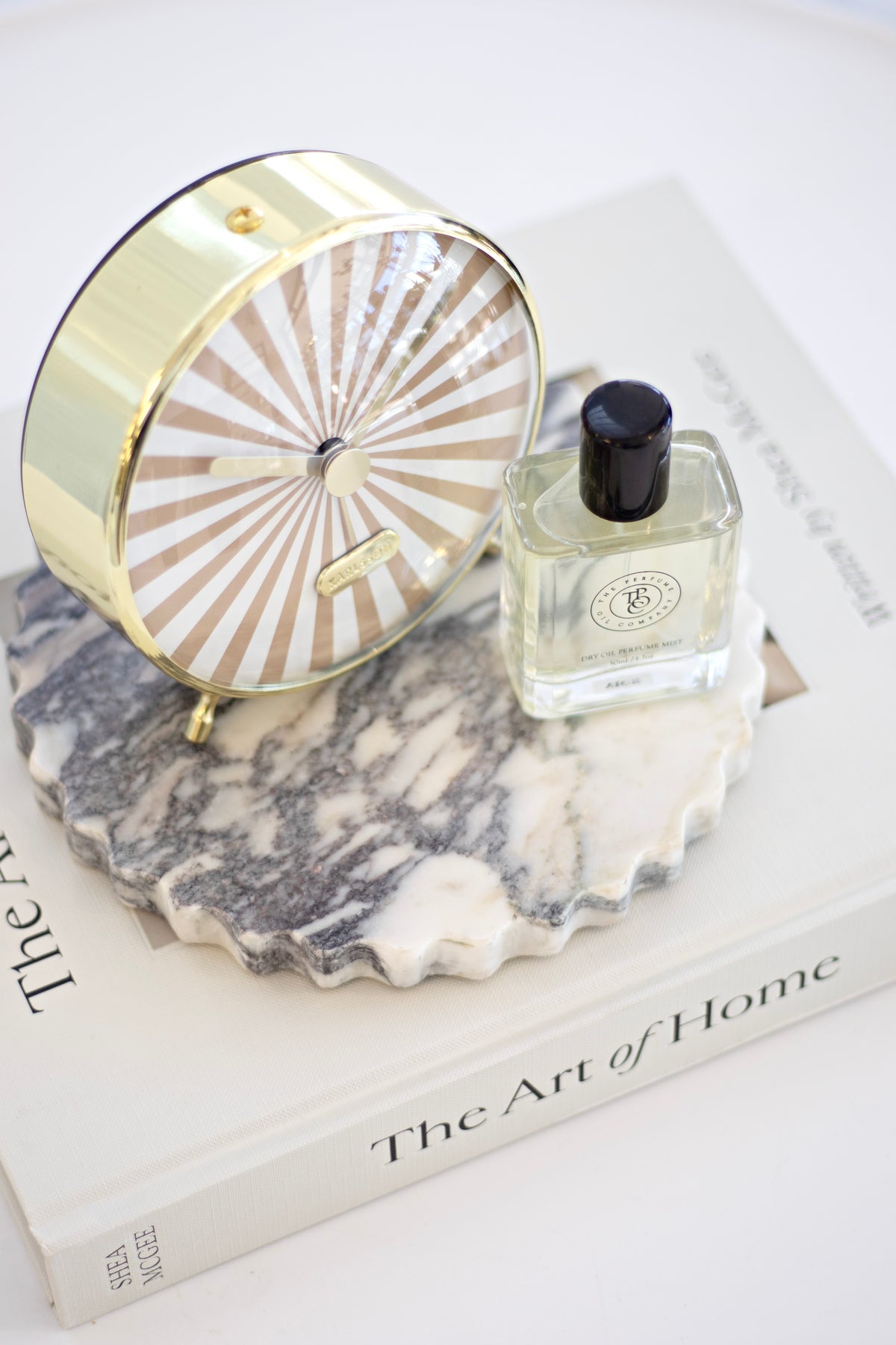 Karlsson Candy Swirl Alarm Clock styled beside a candle and vase