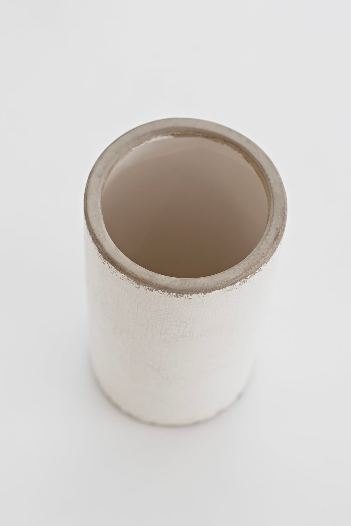 Looking down into the Jardin vase at its smooth taupe glazed interior against the chalky outer finish