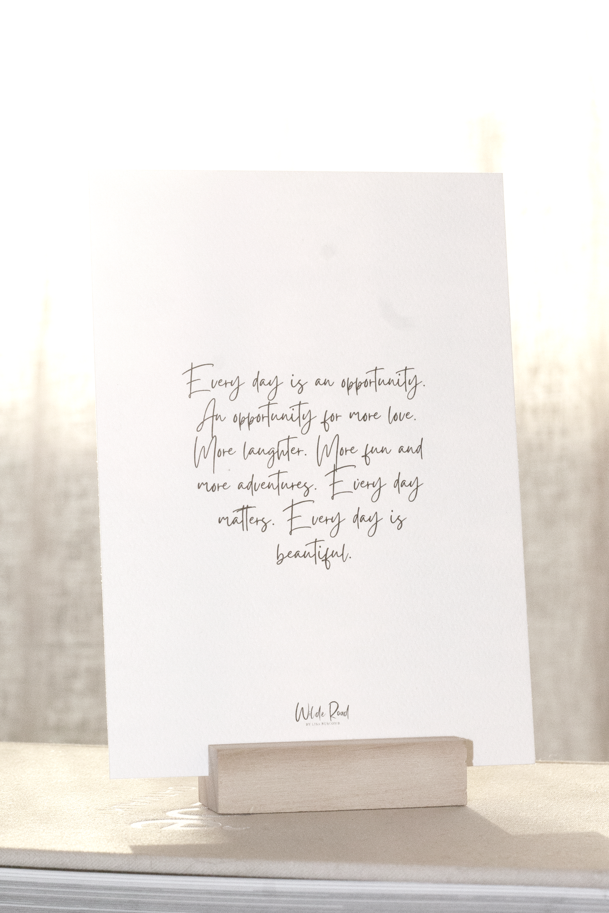 Affirmation card on a wooden stand on a pale surface