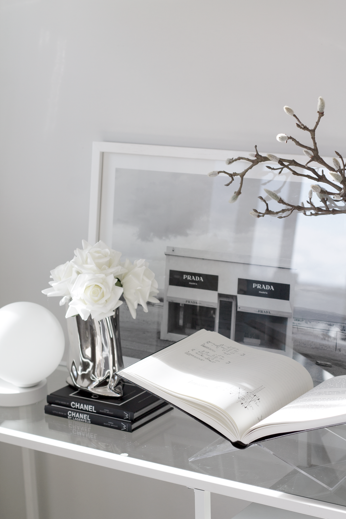 Clear acrylic X-shape book holder displaying an open book