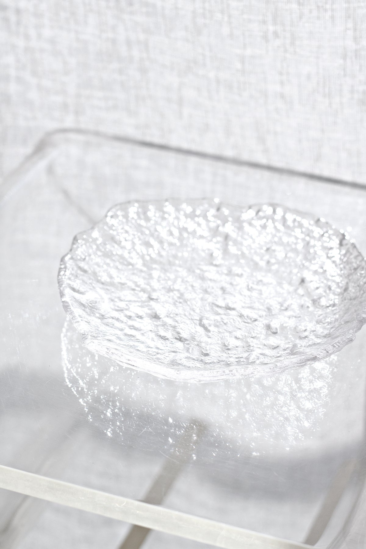 Glacier glass tray on a clear acrylic surface, seen from directly above