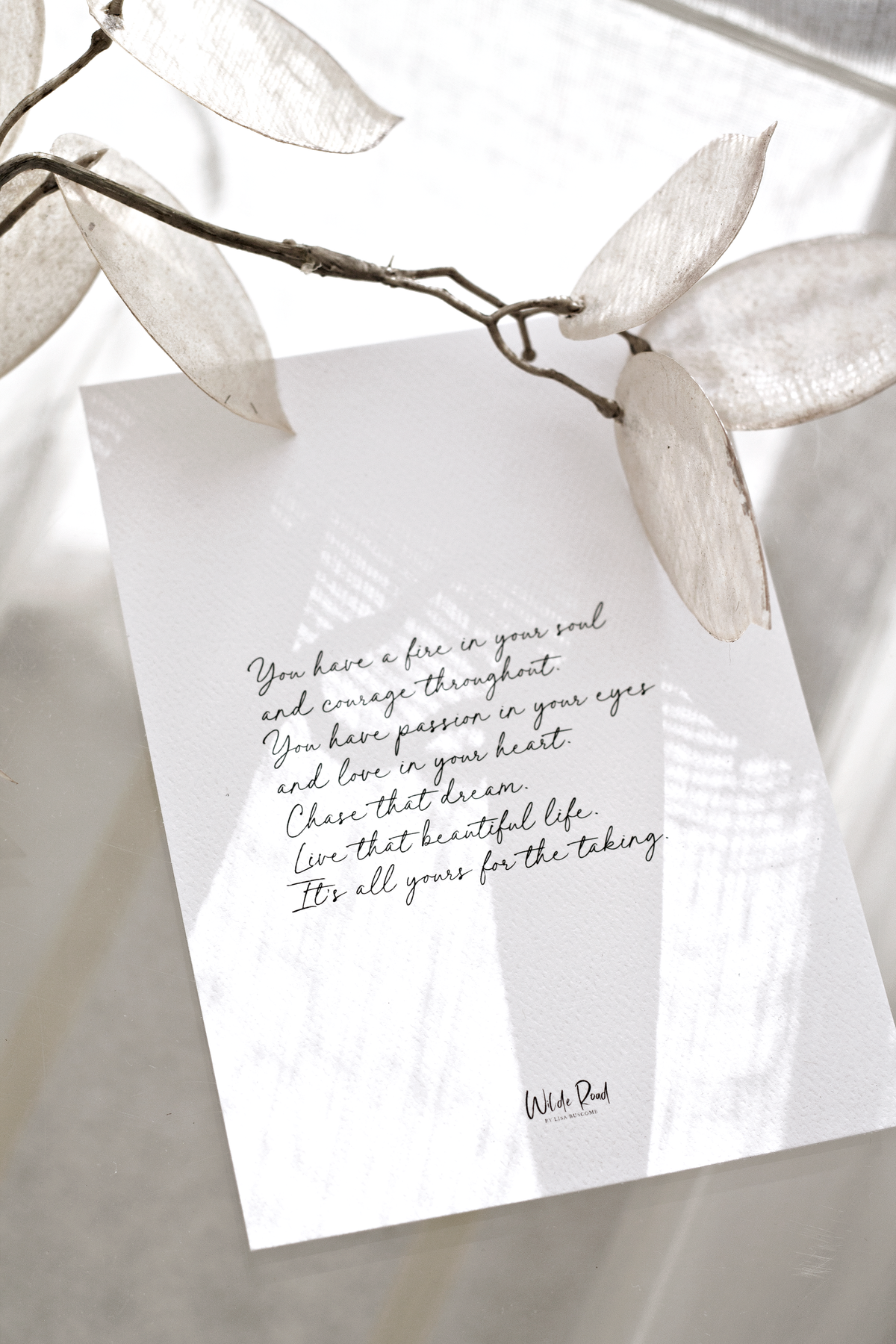 Affirmation card propped against sheer curtains with fairy lights