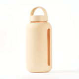 A Day Bottle with Hydration Tracker - Various Options by Bink, beige glass water bottle on a white surface, perfect for daily hydration tracking.
