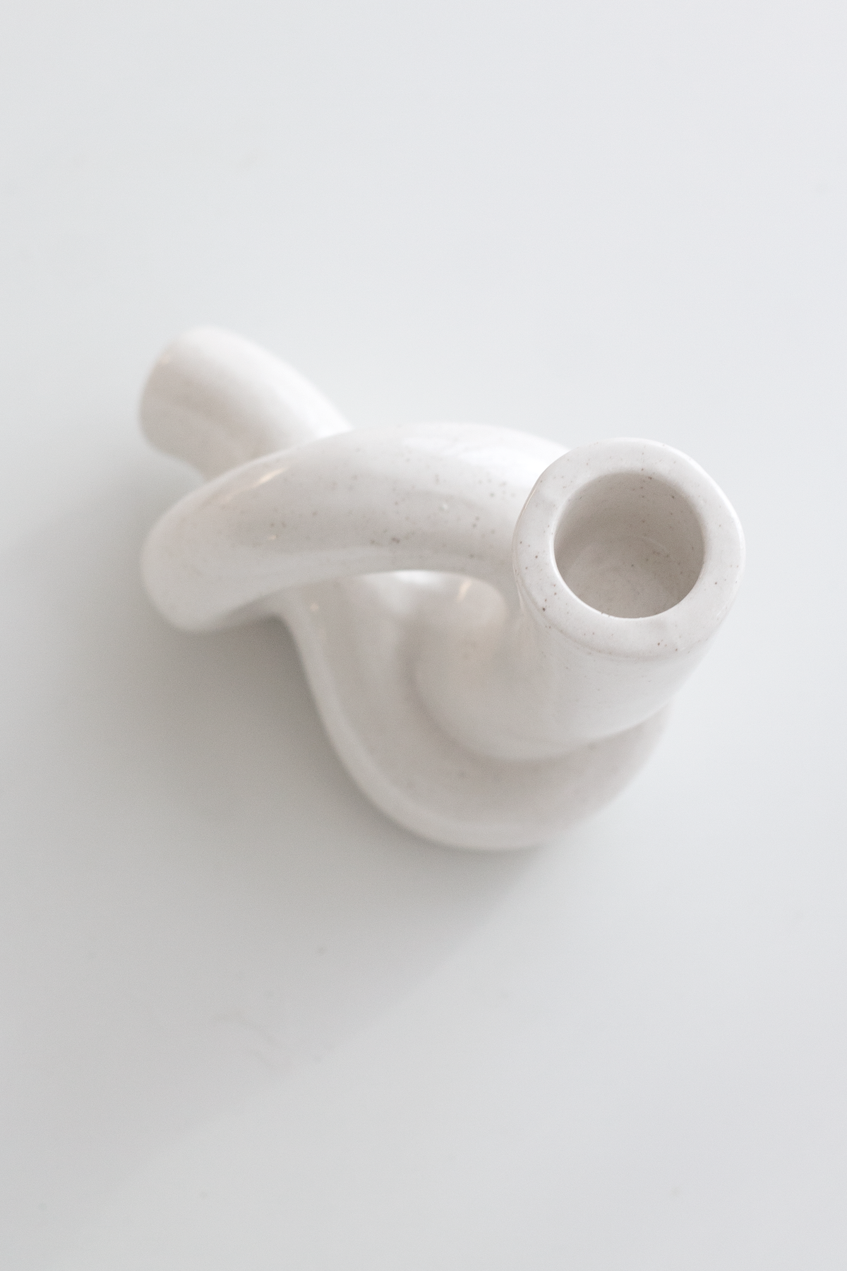 Looking down into the knot candle holder, the taper socket open at the centre of the looped form
