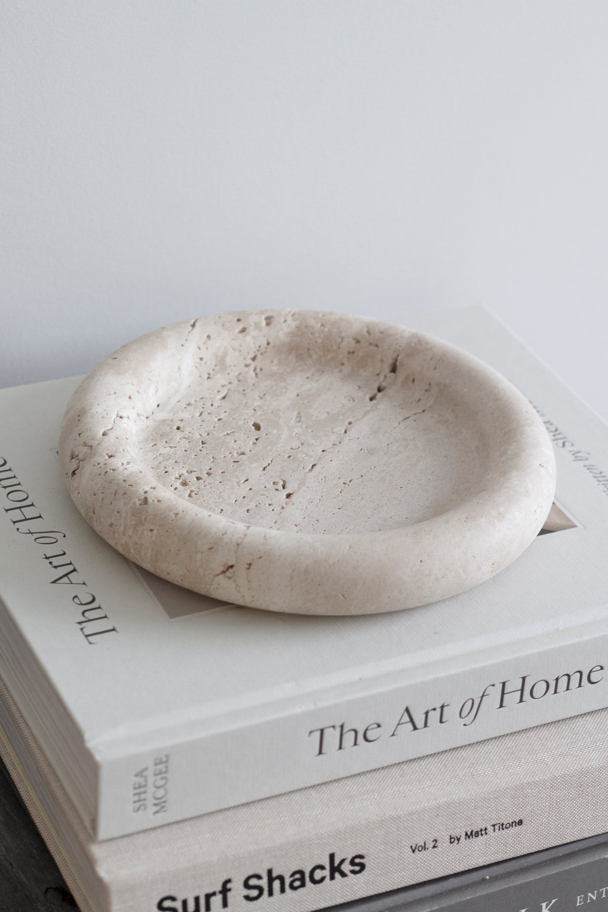 Bay Round Tray on a stack of neutral coffee table books