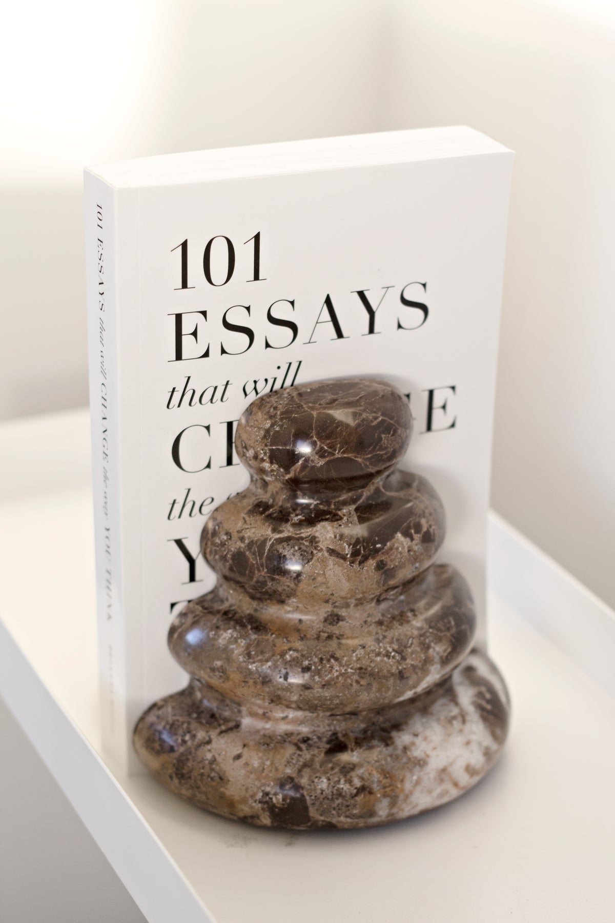 Casa Dark Marble Bookends styled with books on a shelf