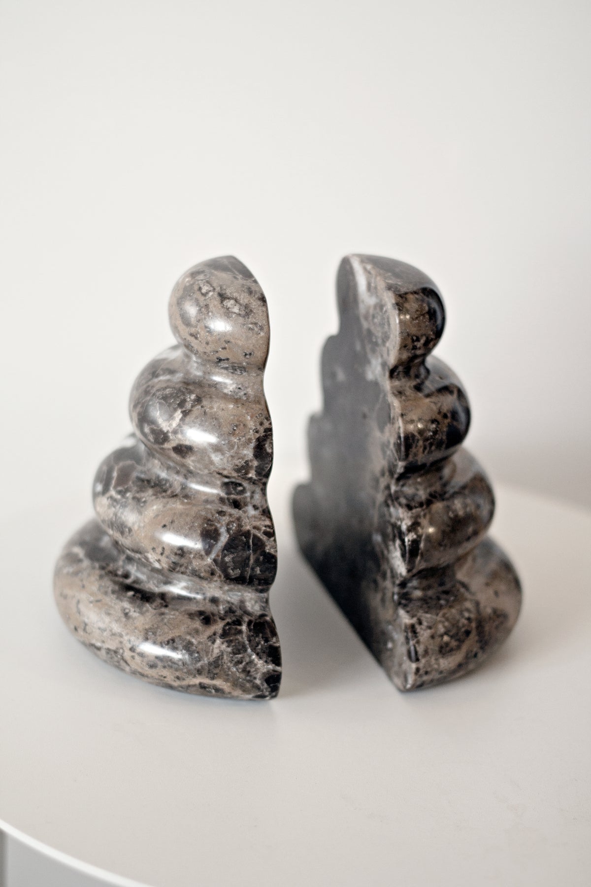 Casa bookends split apart on a white table, showing the flat inner faces